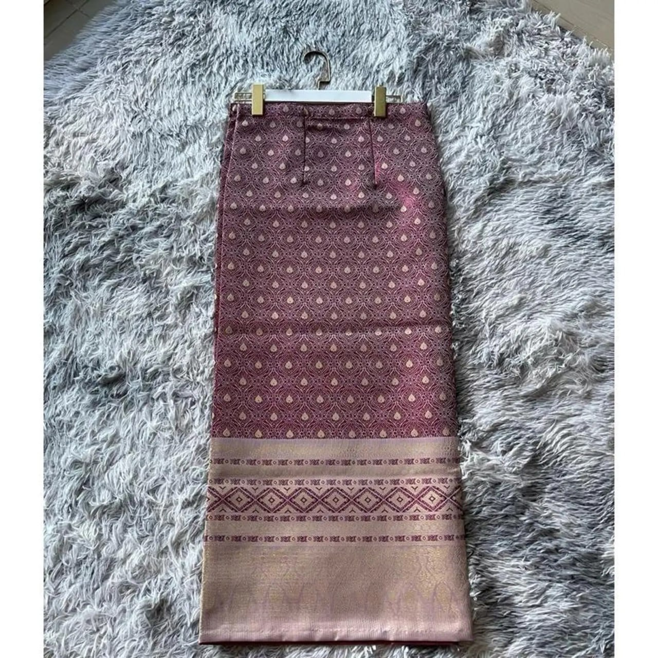 The "Crimson Elegance – Traditional Laotian Sinh Skirt" showcases a classic purplish-red hue